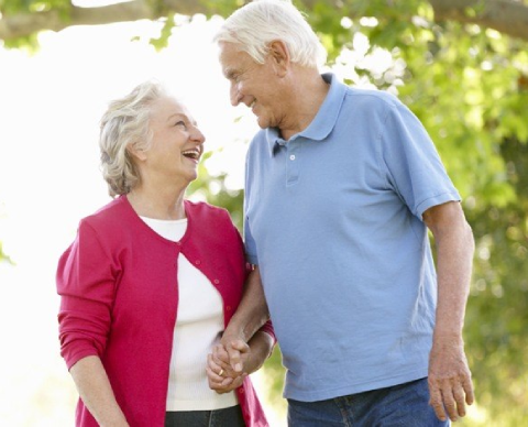 A man and woman holding hands while standing next to each other.