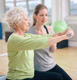 A woman and an older person are doing exercises.